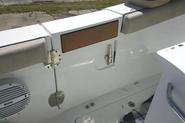 Slide: The Image of 2022 Sea Pro 259 Center Console boat interior, featuring storage compartment and speaker. - 49