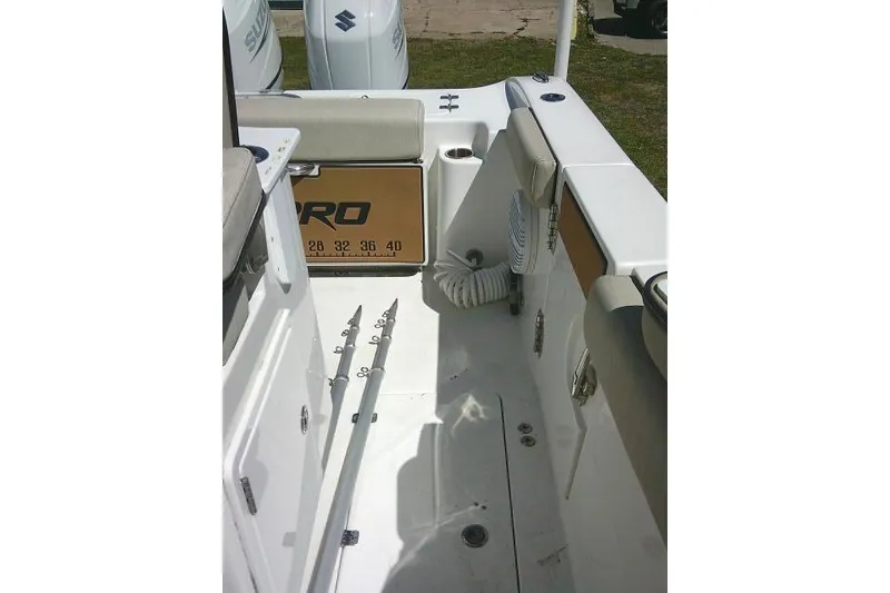 Slide: The Image of 2022 Sea Pro 259 Center Console boat interior with fishing rod holders and storage. - 53
