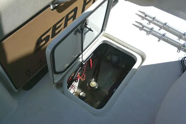 Slide: The Image of 2022 Sea Pro 259 Center Console boat hatch with open storage compartment. - 56