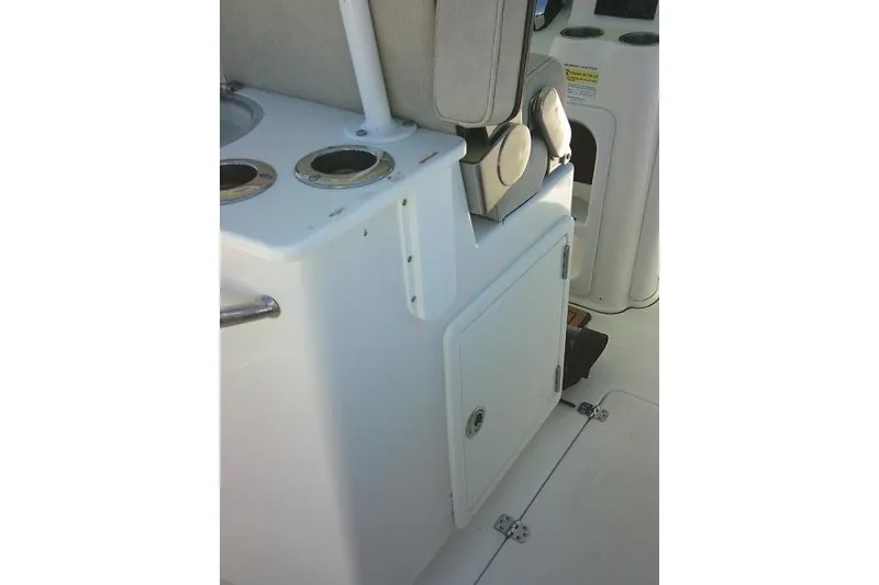 Slide: The Image of 2022 Sea Pro 259 Center Console interior with storage compartment and cup holders. - 59