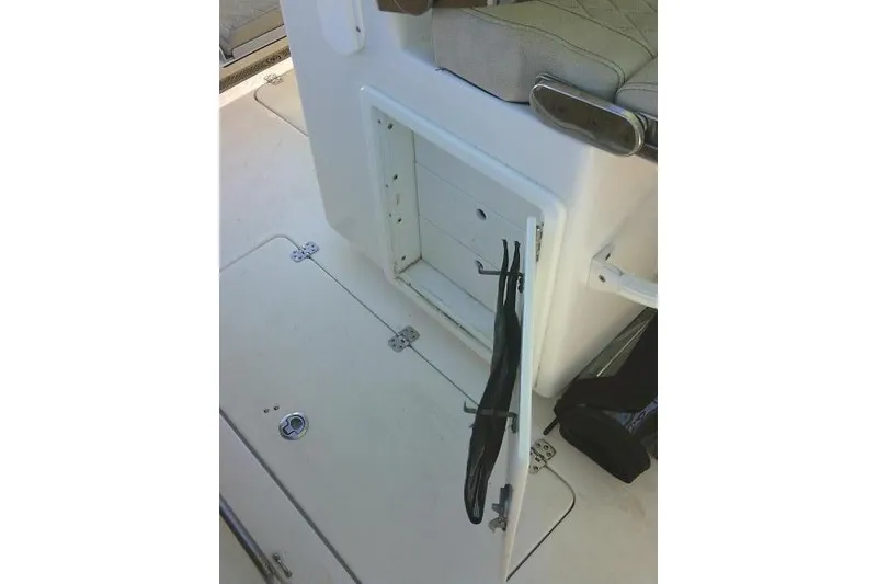 Slide: The Image of Open storage compartment on 2022 Sea Pro 259 Center Console boat deck. - 64