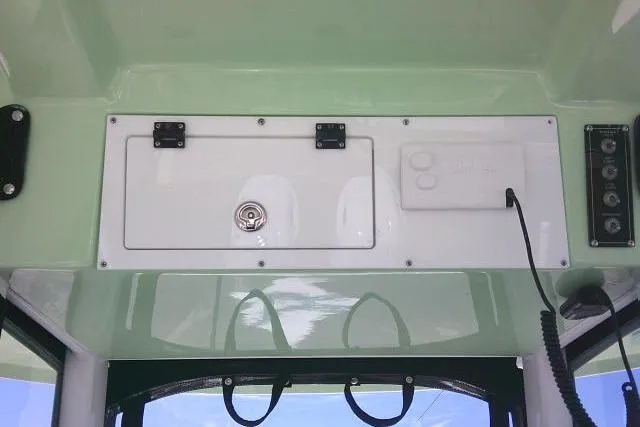 Slide: The Image of 2022 Sea Pro 259 Center Console dashboard with storage compartments and control panel. - 74