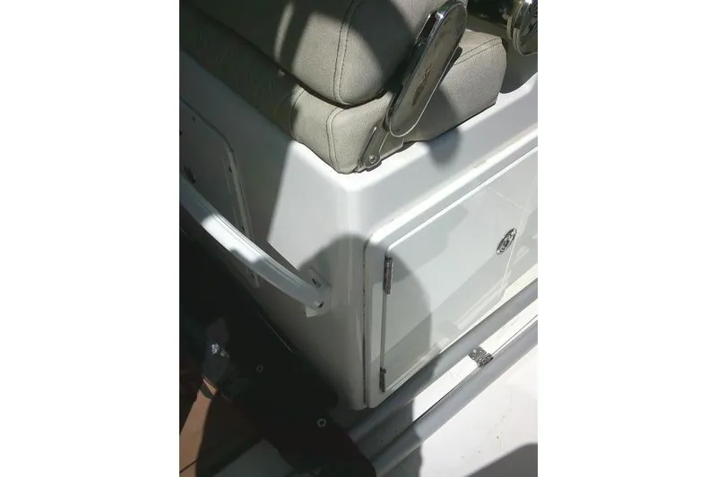 Slide: The Image of 2022 Sea Pro 259 Center Console boat interior with cushioned seating and storage compartment. - 78