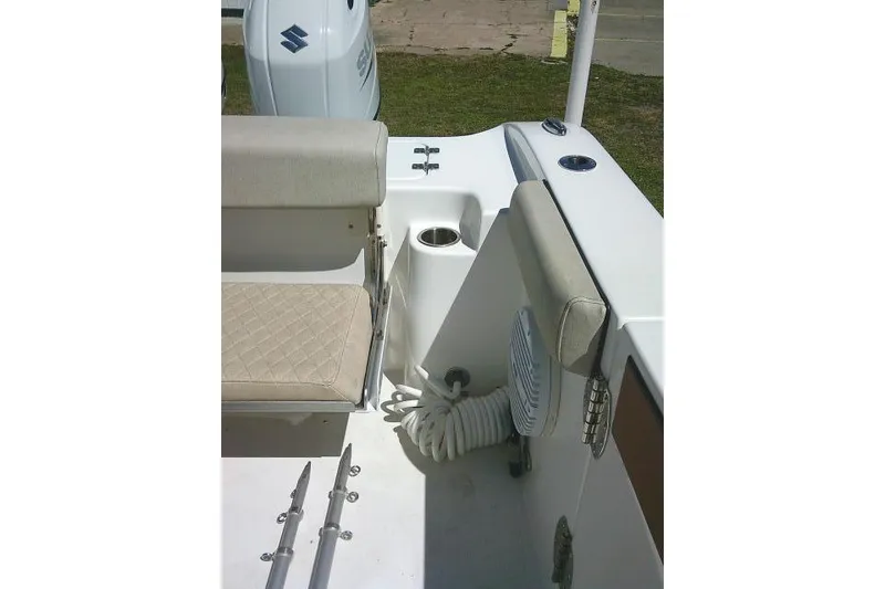 Slide: The Image of 2022 Sea Pro 259 Center Console boat interior with seating and coiled hose. - 79