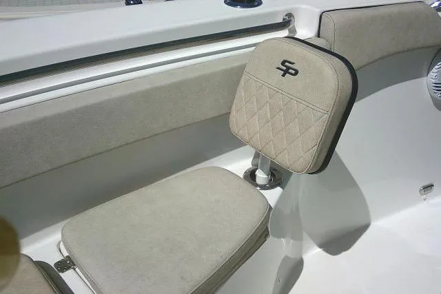 Slide: The Image of 2022 Sea Pro 259 Center Console boat seat with beige upholstery and logo. - 80