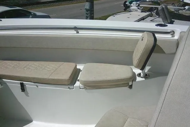 Slide: The Image of 2022 Sea Pro 259 Center Console boat seating area with cushioned seats. - 82
