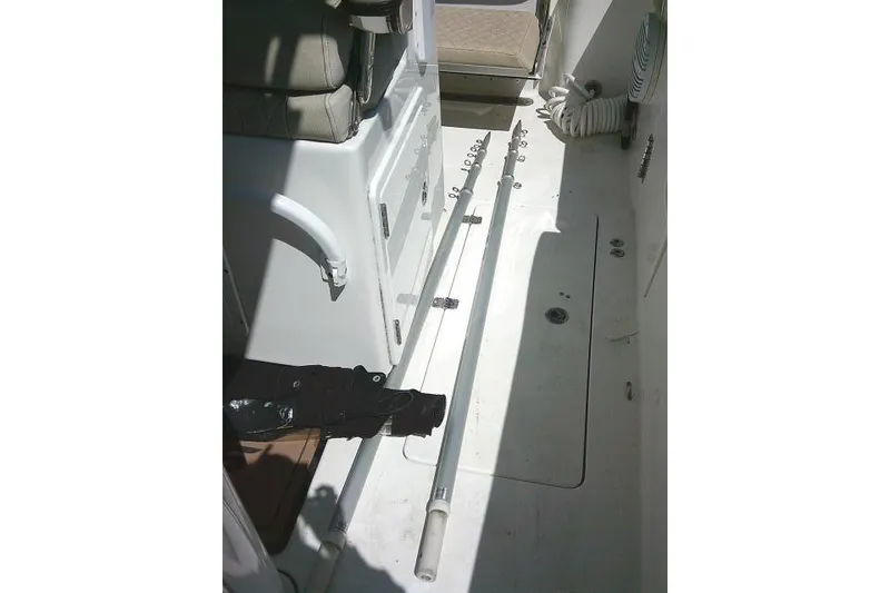 Slide: The Image of 2022 Sea Pro 259 Center Console interior with fishing rods and storage area. - 83