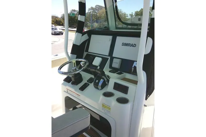 Slide: The Image of 2022 Sea Pro 259 Center Console boat dashboard with Simrad electronics. - 84