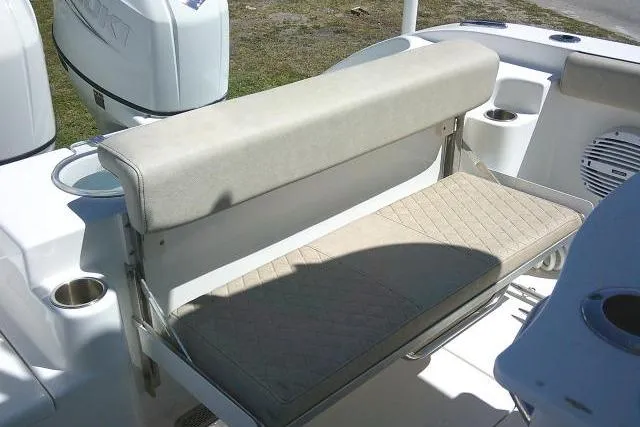 Slide: The Image of 2022 Sea Pro 259 Center Console boat seat with cup holders and storage. - 87