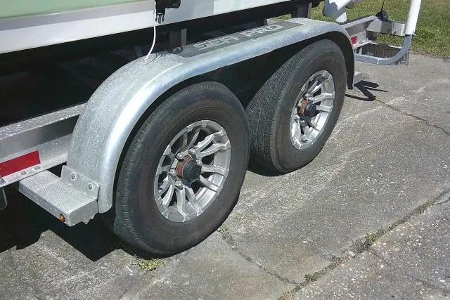 Slide: The Image of Trailer wheels of a 2022 Sea Pro 259 Center Console boat on pavement. - 9