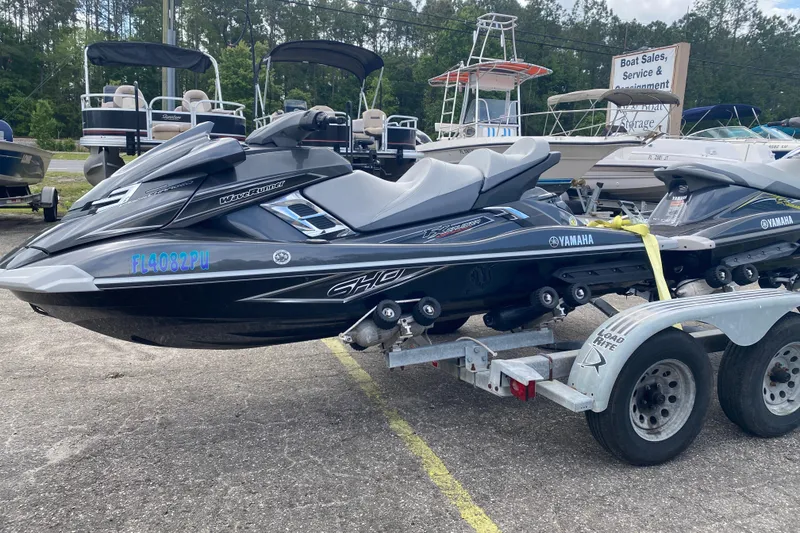 Slide: The Image of 2013 Yamaha WaveRunner FX Cruiser SHO on trailer, parked at a boat sales lot. - 1