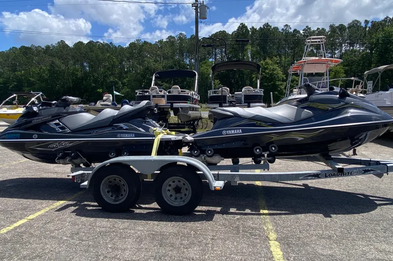 Slide: The Image of 2013 Yamaha WaveRunner FX Cruiser SHO jet skis on a trailer in a parking lot. - 10