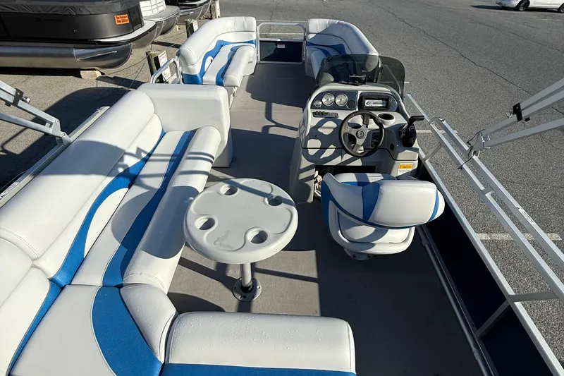Slide: The Image of 2012 SunCatcher LV 228 Cruise pontoon boat interior with seating and steering console. - 11