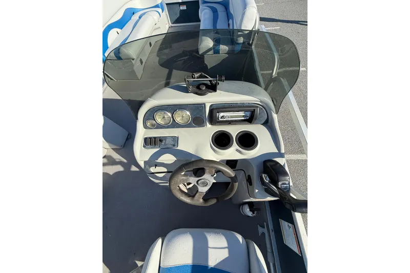 Slide: The Image of 2012 SunCatcher LV 228 Cruise boat dashboard with steering wheel and controls. - 13