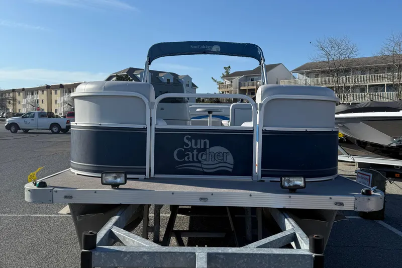 Slide: The Image of 2012 SunCatcher LV 228 Cruise pontoon boat on trailer in parking lot. - 3