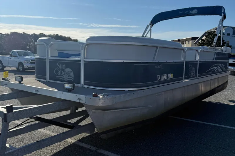 Slide: The Image of 2012 SunCatcher LV 228 Cruise pontoon boat on trailer in parking lot. - 4