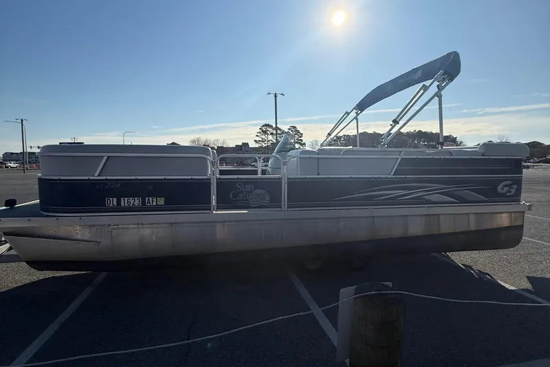 Slide: The Image of 2012 SunCatcher LV 228 Cruise pontoon boat parked under a clear blue sky. - 5