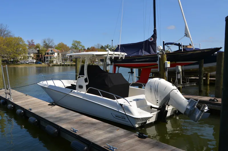 The Image of 2021 Boston Whaler 270 Dauntless docked at a marina, showcasing its sleek design. - 0