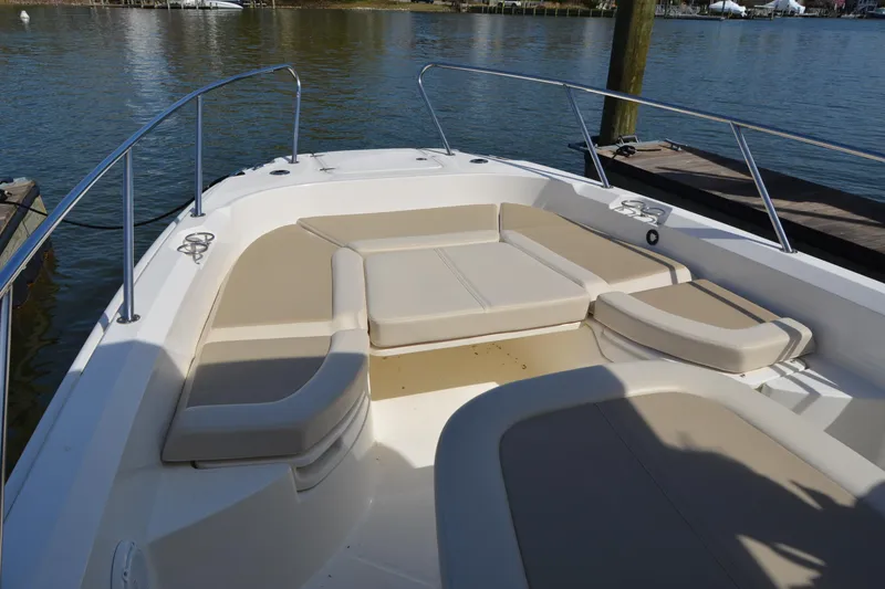 Slide: The Image of 2021 Boston Whaler 270 Dauntless boat with spacious seating area on calm water. - 10