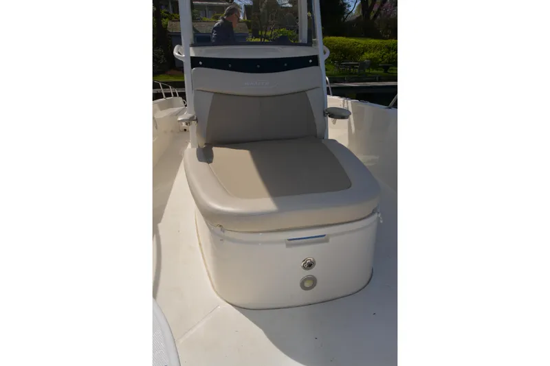 Slide: The Image of 2021 Boston Whaler 270 Dauntless boat seat with beige cushion and storage compartment. - 17