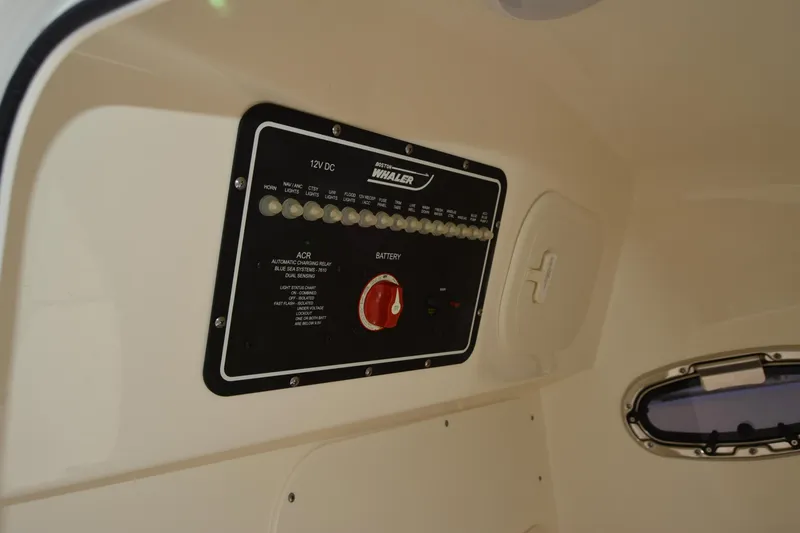 Slide: The Image of 2021 Boston Whaler 270 Dauntless control panel with switches and battery indicator. - 19