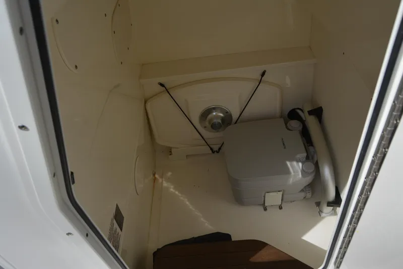 Slide: The Image of Interior view of 2021 Boston Whaler 270 Dauntless boat's compact restroom area. - 22