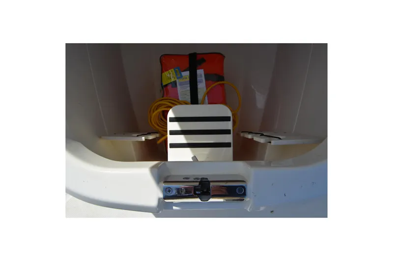 Slide: The Image of 2021 Boston Whaler 270 Dauntless storage compartment with life jacket and rope. - 26
