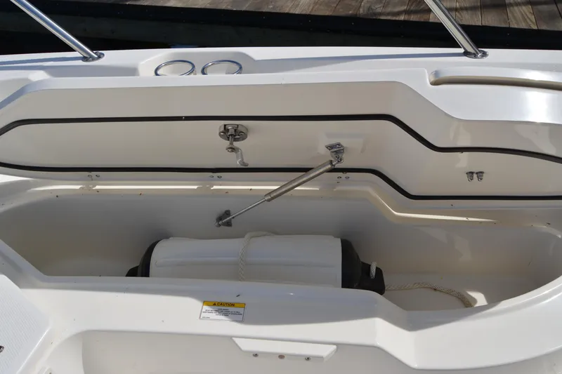 Slide: The Image of Storage compartment of a 2021 Boston Whaler 270 Dauntless boat, featuring a fender and rope. - 28
