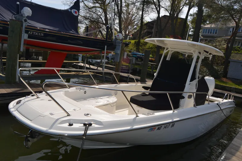Slide: The Image of 2021 Boston Whaler 270 Dauntless boat docked in a marina setting. - 3