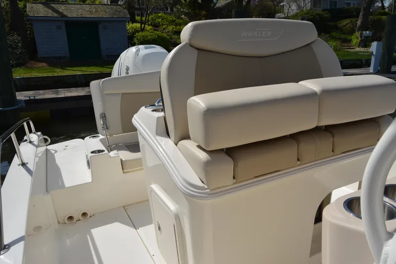Slide: The Image of 2021 Boston Whaler 270 Dauntless boat interior with beige seating and cup holders. - 30