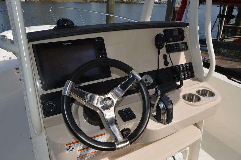 Slide: The Image of 2021 Boston Whaler 270 Dauntless helm with steering wheel and navigation controls. - 39