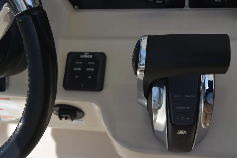 Slide: The Image of 2021 Boston Whaler 270 Dauntless helm controls with steering wheel and throttle lever. - 46