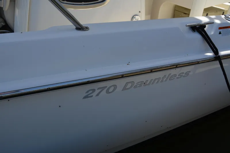 Slide: The Image of 2021 Boston Whaler 270 Dauntless boat side view with model name visible. - 5