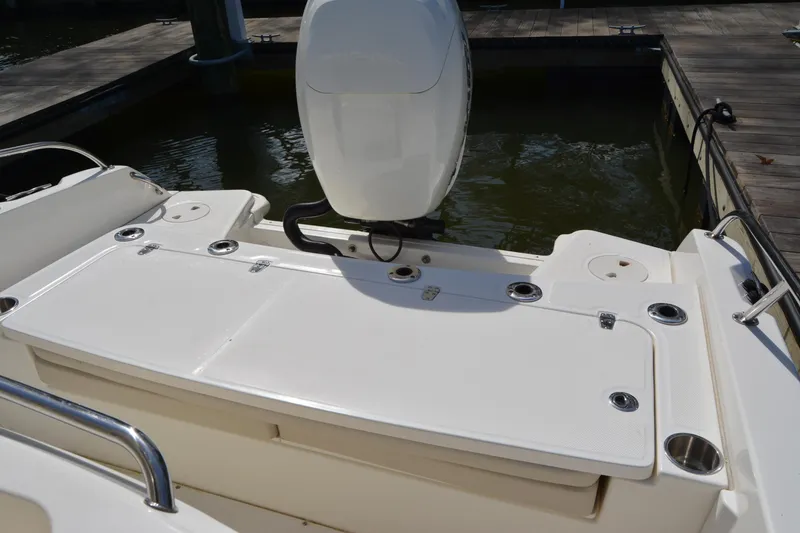 Slide: The Image of 2021 Boston Whaler 270 Dauntless boat stern view with motor and rod holders. - 52