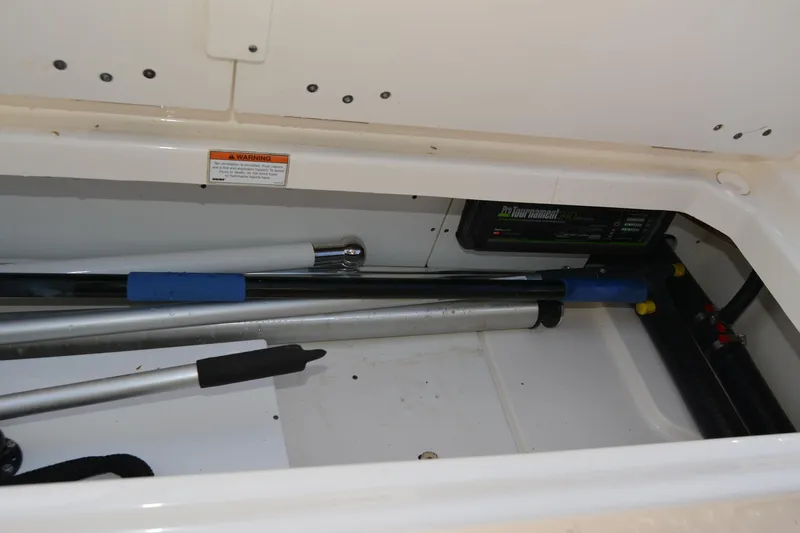 Slide: The Image of Storage compartment of a 2021 Boston Whaler 270 Dauntless boat with equipment and tools. - 56