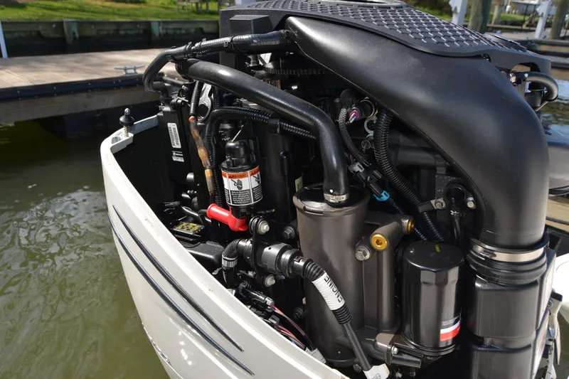 Slide: The Image of Close-up of a 2021 Boston Whaler 270 Dauntless boat engine at a dock. - 61