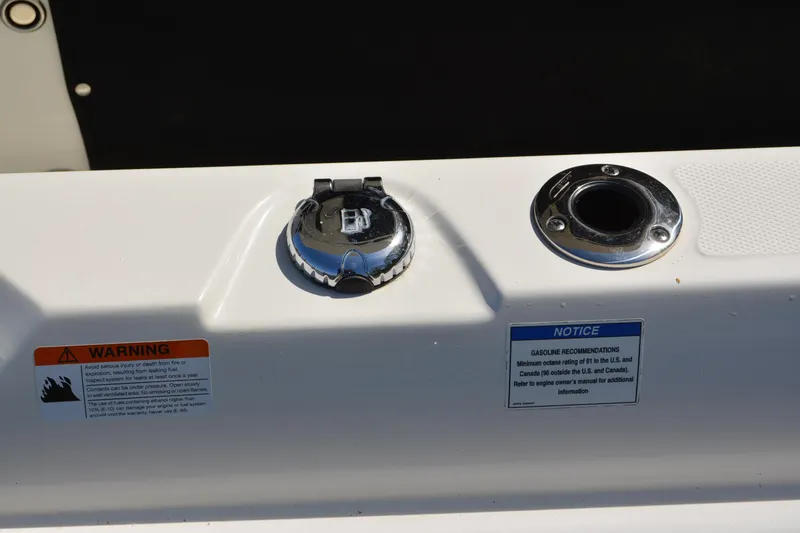 Slide: The Image of Fuel cap and warning labels on a 2021 Boston Whaler 270 Dauntless boat. - 64