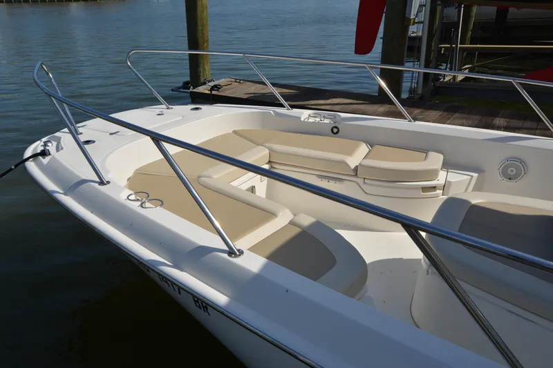 Slide: The Image of 2021 Boston Whaler 270 Dauntless boat with spacious seating, docked by the water. - 7
