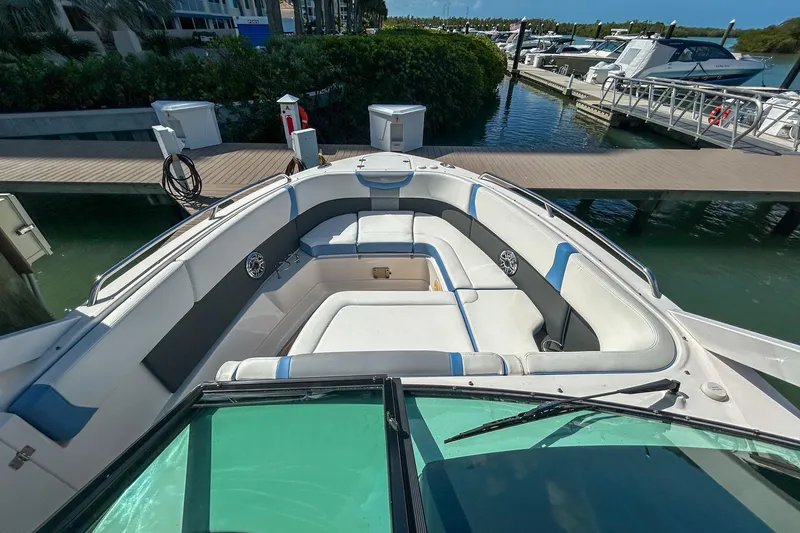 Slide: The Image of 2023 Chaparral 280 OSX boat interior with spacious seating at marina dock. - 12