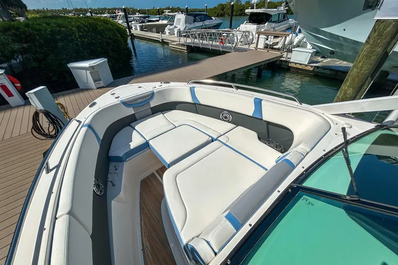 Slide: The Image of 2023 Chaparral 280 OSX boat with spacious seating at marina dock. - 13