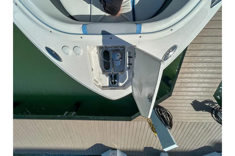 Slide: The Image of Overhead view of 2023 Chaparral 280 OSX boat's bow with open storage compartment. - 15