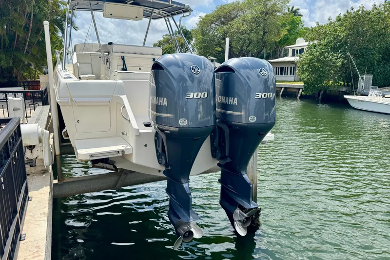 Slide: The Image of 2001 Intrepid 339 Walkaround with twin Yamaha 300 engines docked by water. - 12