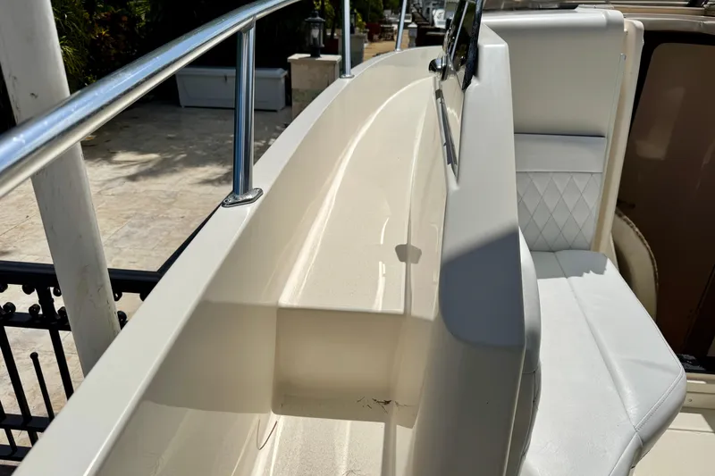 Slide: The Image of 2001 Intrepid 339 Walkaround boat interior with white seating and railing. - 28