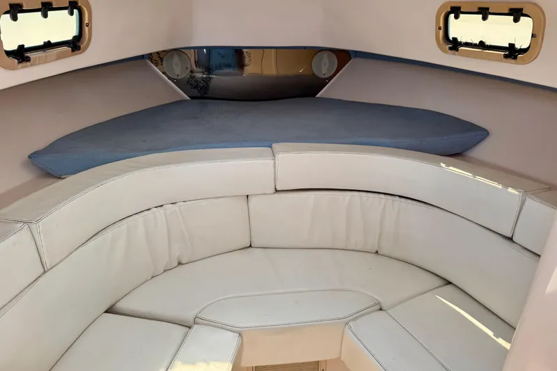 Slide: The Image of Interior cabin of a 2001 Intrepid 339 Walkaround boat with cushioned seating. - 30