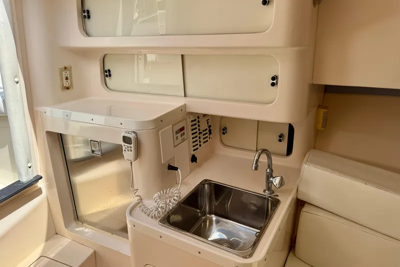 Slide: The Image of 2001 Intrepid 339 Walkaround interior with sink, storage, and communication equipment. - 32