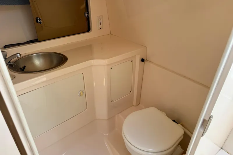 Slide: The Image of 2001 Intrepid 339 Walkaround boat bathroom with sink and toilet. - 34