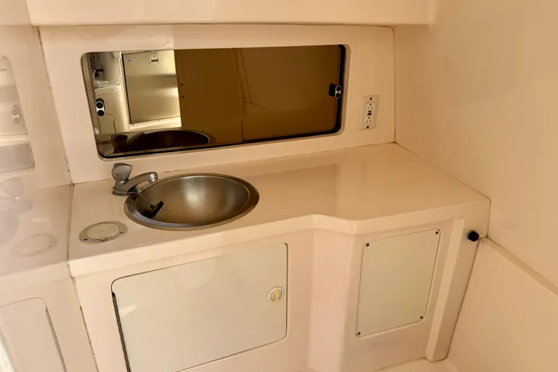 Slide: The Image of Compact sink area in 2001 Intrepid 339 Walkaround boat interior. - 35