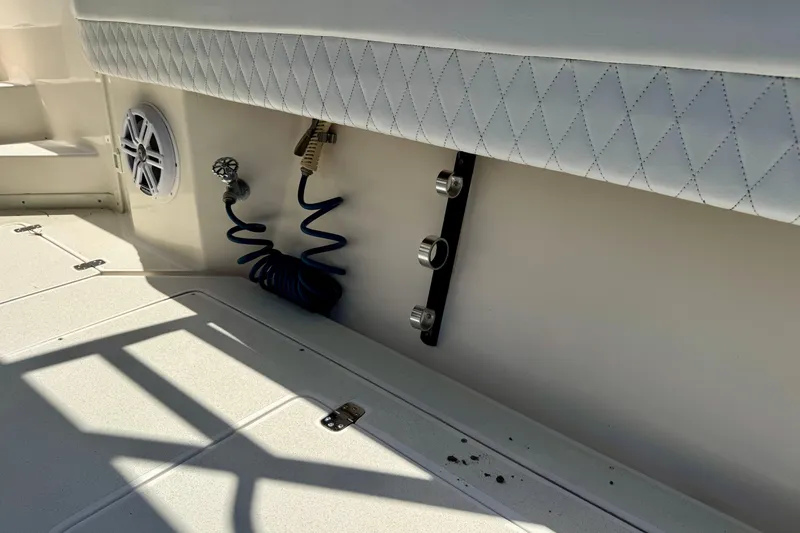 Slide: The Image of Interior of 2001 Intrepid 339 Walkaround boat with speaker and coiled hose. - 45