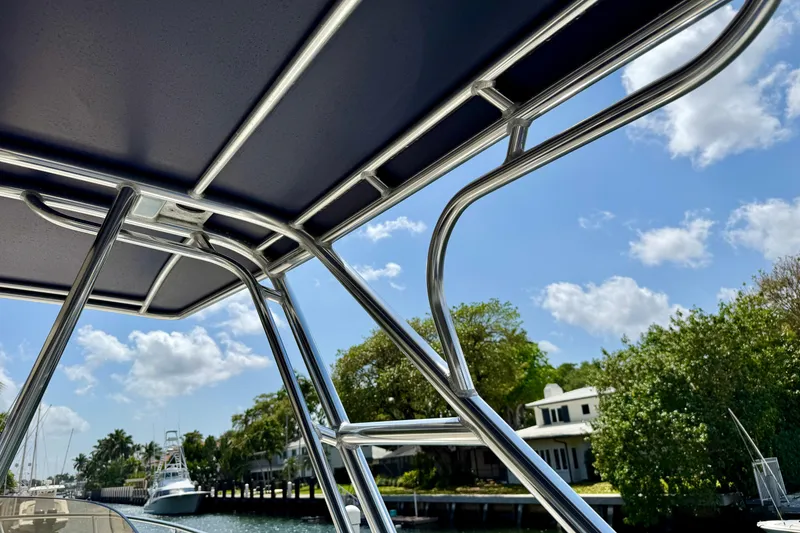 Slide: The Image of View from a 2001 Intrepid 339 Walkaround boat, showcasing sleek metal framework and sunny skies. - 49