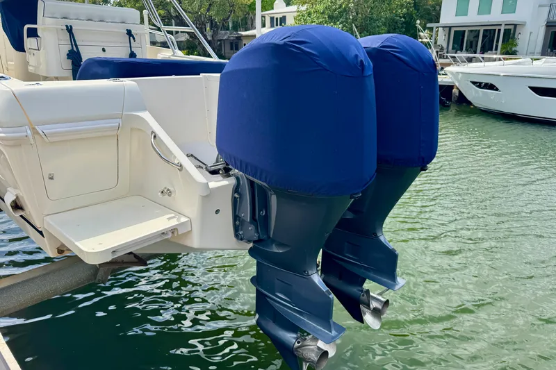 Slide: The Image of 2001 Intrepid 339 Walkaround with dual covered outboard motors docked in marina. - 5